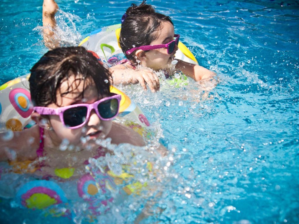 Kids in innertubes at luxury hotel pool in San Diego