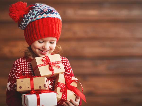 Girl at Christmas with gift boxes