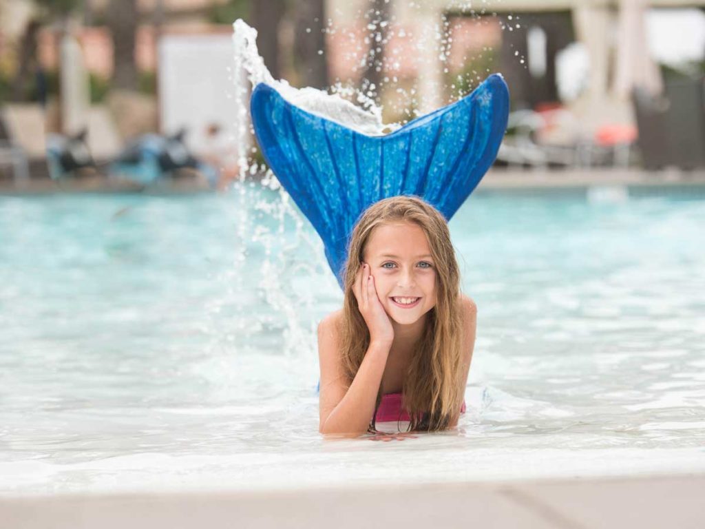 A girl wearing a mermaid tail in the San Diego Mission Bay Resort pool.