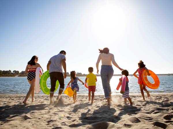 A family playing on the beach.