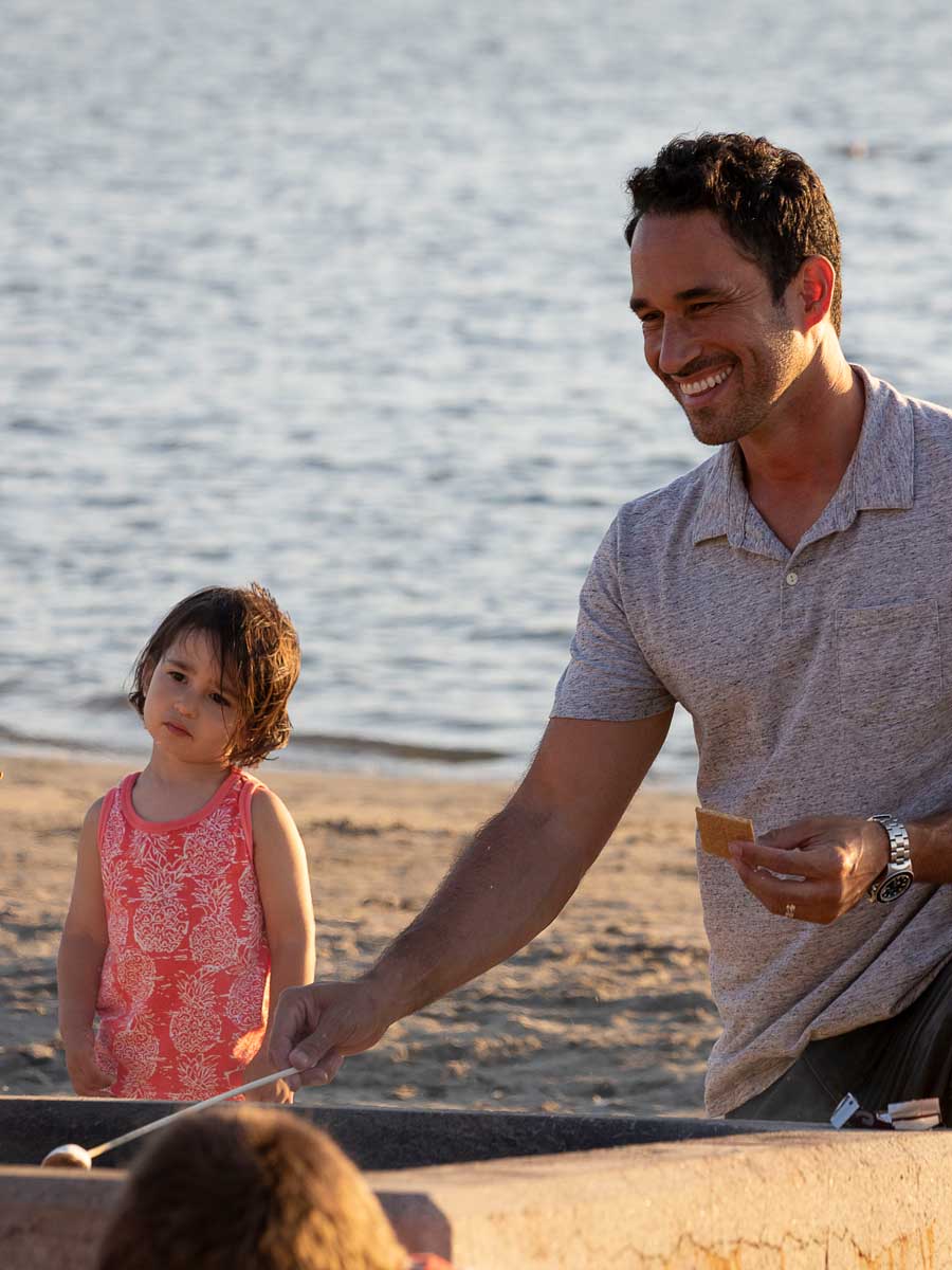 Dad and daughter making a smore.