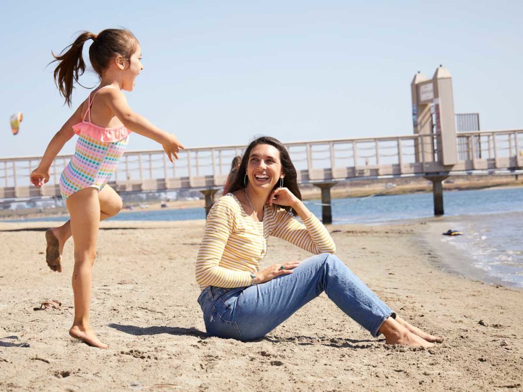 Mom and daughter on the beach.