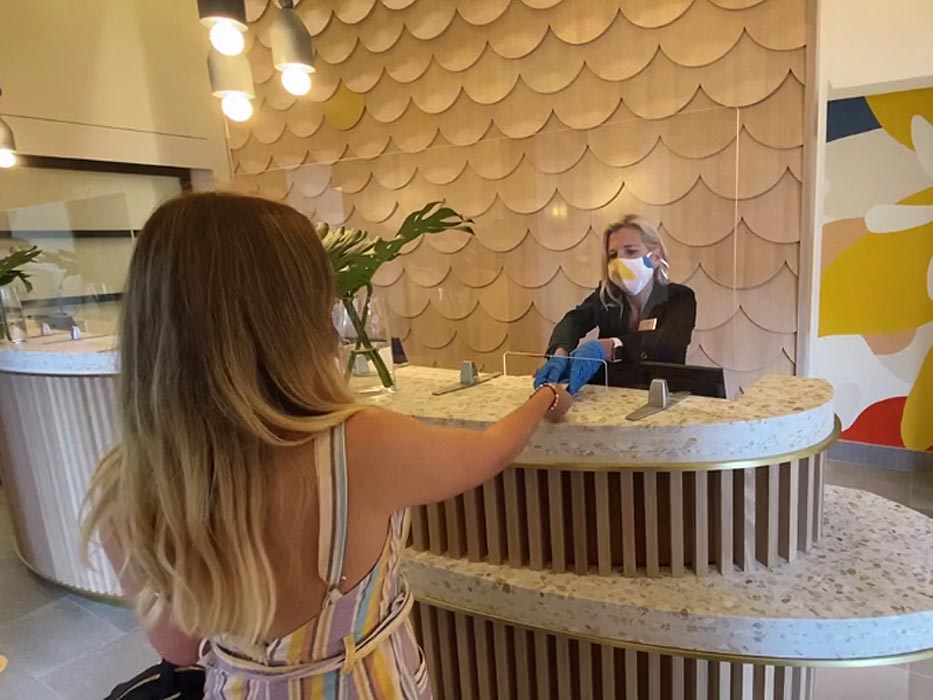 woman checking in the hotel at front desk