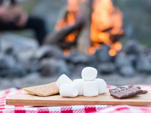 Smores Ingredients Next To A Campfire.