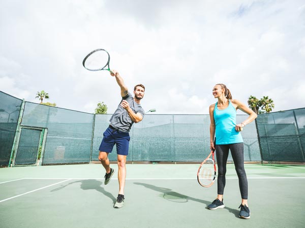 Couple Playing Tennis.