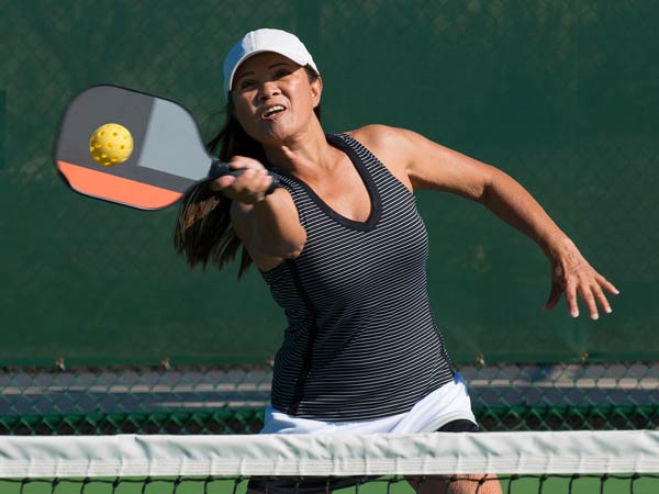 Lady Playing Pickleball.