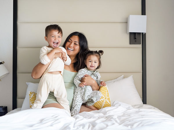 Mom And Kids On Bed