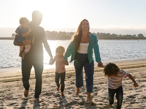 Family Walking On The Beach In San Diego