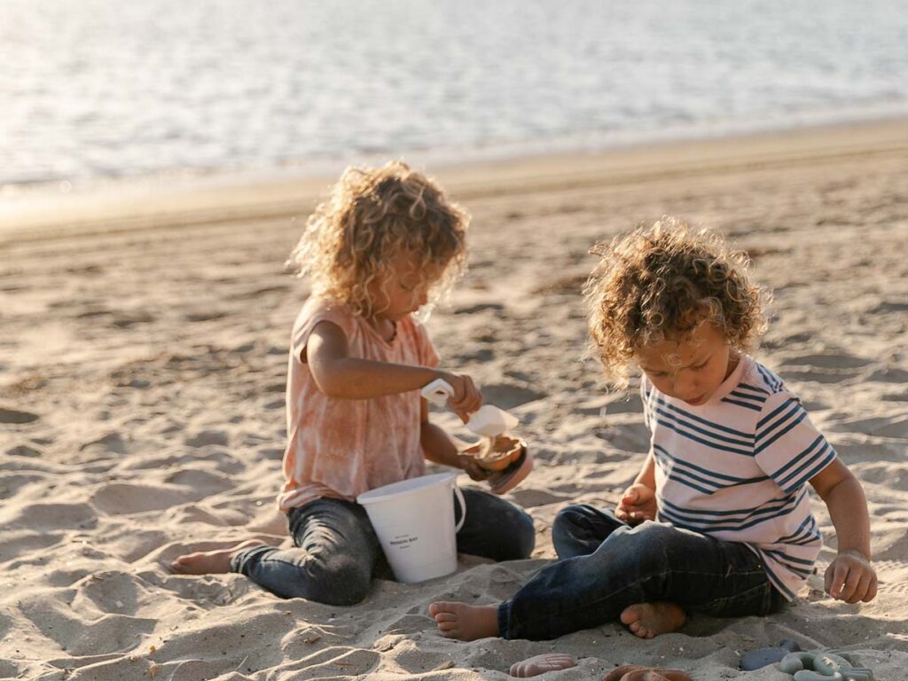 Kids Playing In The Sand On The Beach
