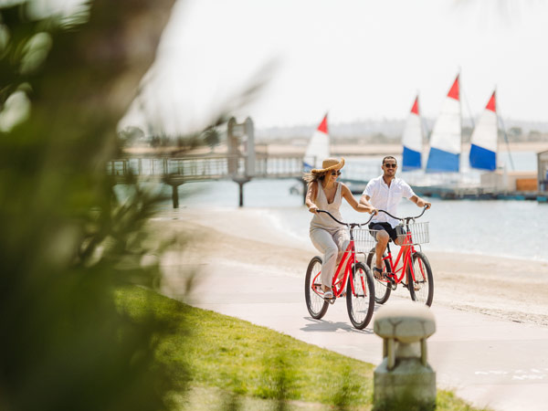 Couple Biking By The Ocean