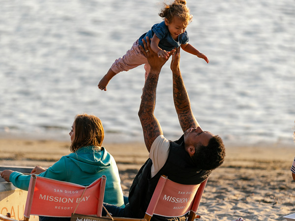 Family Having Fun On The Beach