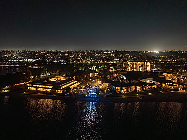 San Diego Mission Bay Resort lit up at night with bayfront accommodations and tropical landscaping reflected in Mission Bay