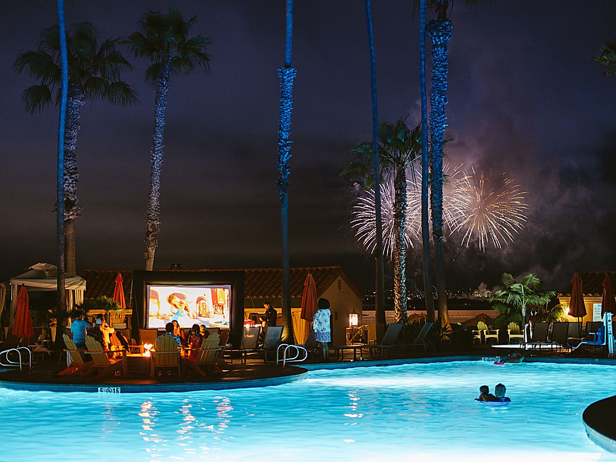 Dive-in movie night and bay fireworks at San Diego Mission Bay Resort's palm-lined pool.