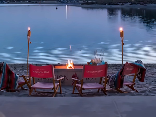 Beachfront fire pit at dusk with s'mores and bay views at San Diego Mission Bay Resort