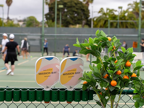 Branded pickleball paddles and active courts at San Diego Mission Bay Resort