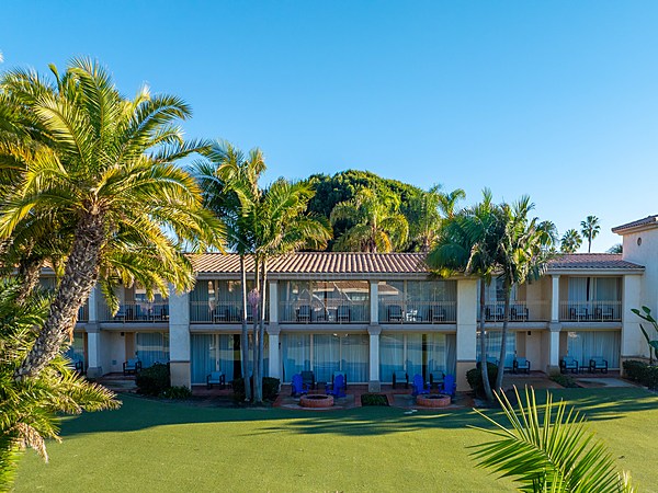 Palm-lined guest rooms with patio fire pits at San Diego Mission Bay Resort
