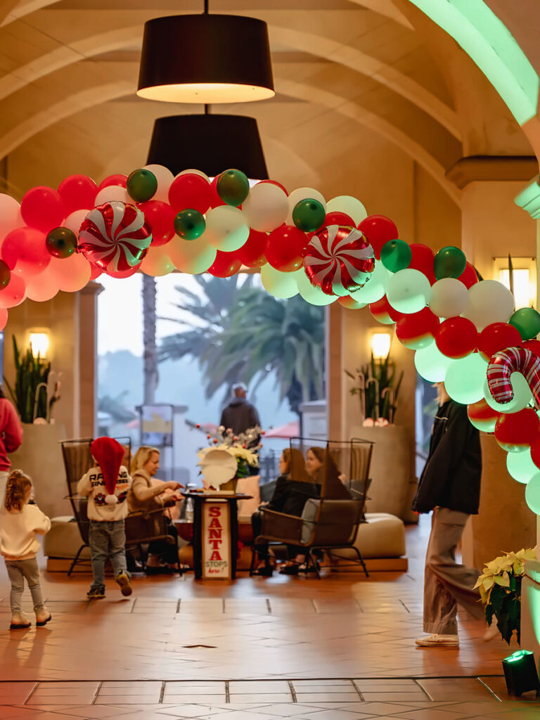 Holiday balloon arch framing the lobby archway at San Diego Mission Bay Resort.