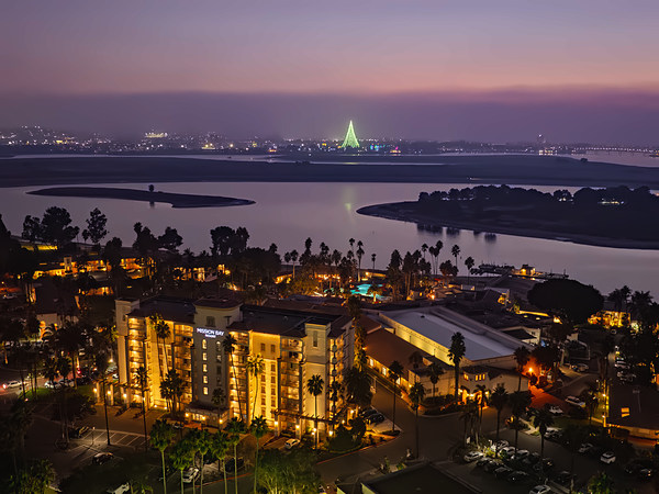 Aerial twilight view of San Diego Mission Bay Resort with holiday lights across Mission Bay.